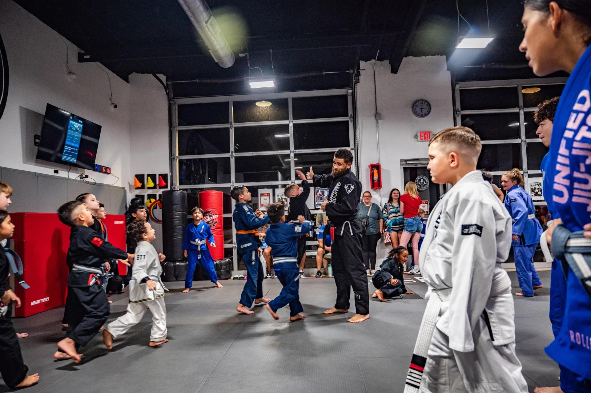 Adult BJJ students drilling technique at Unified Jiu Jitsu.