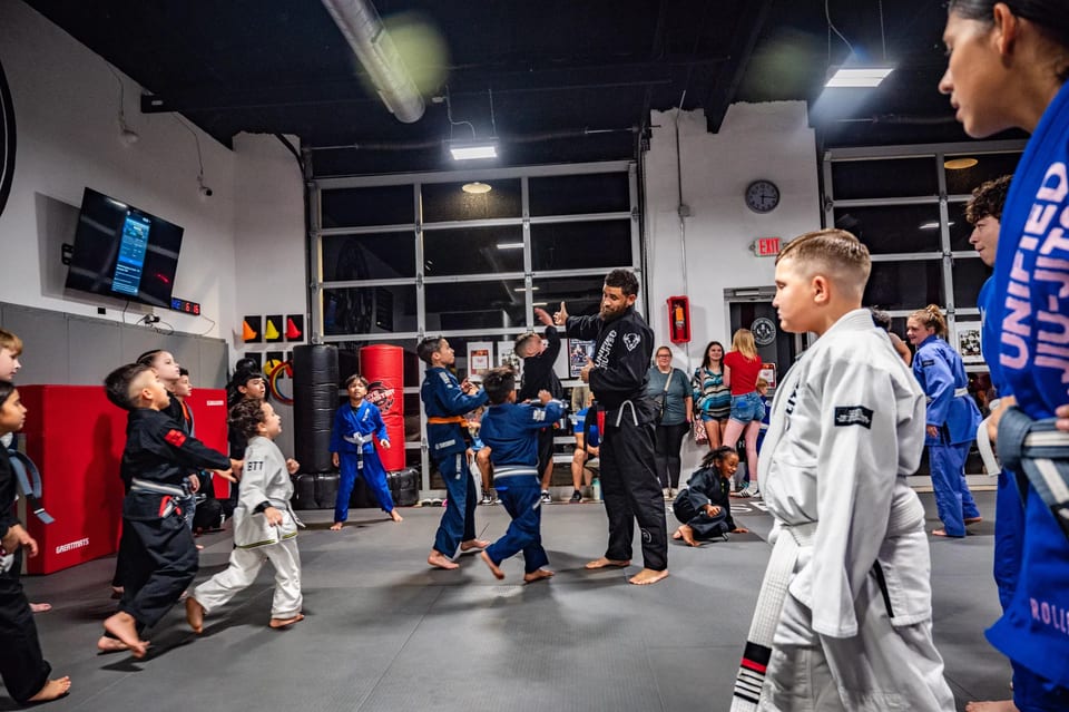 Adult class practicing technique with coaches.